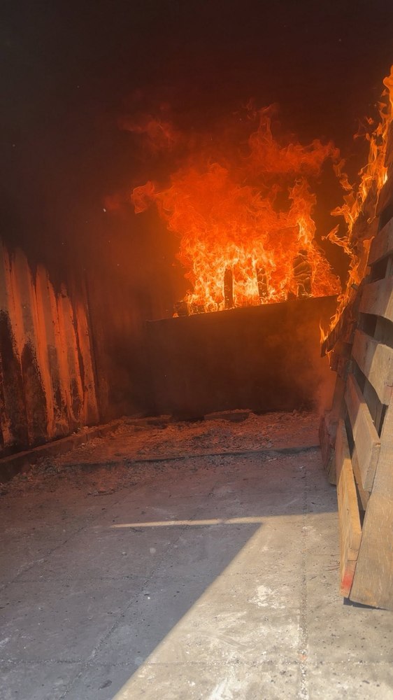 Flames inside a live-fire training burn container