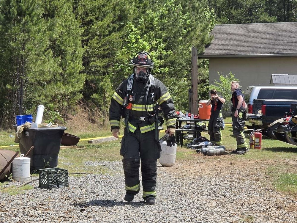 Firefighter in full gear at a residential live-burn training exercise