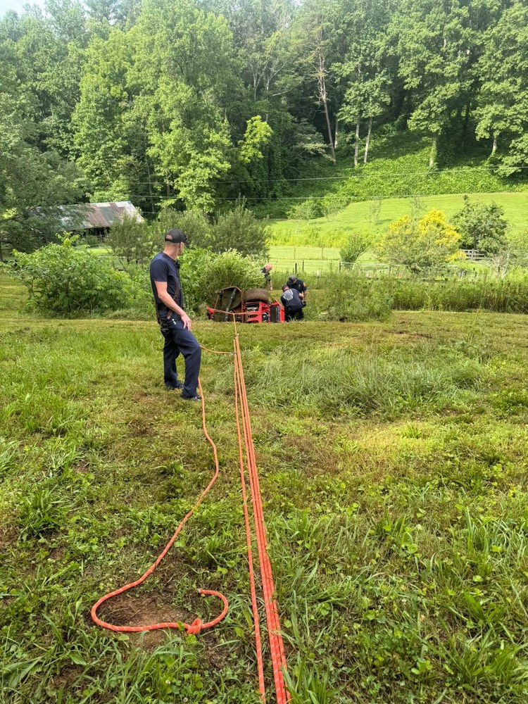 Gilmer County Fire/Rescue members conducting a recovery operation in a field