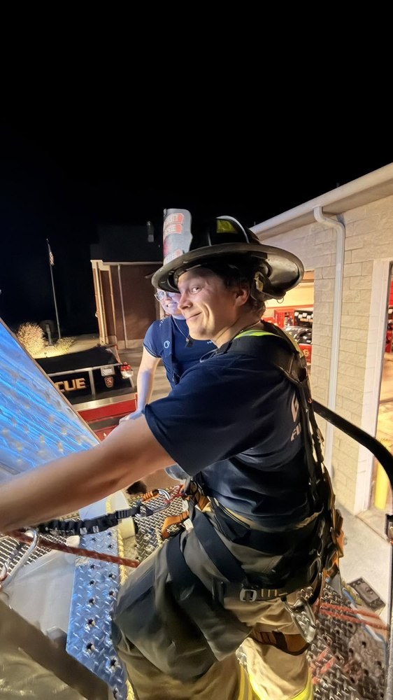 Firefighter on the aerial platform at the station at night