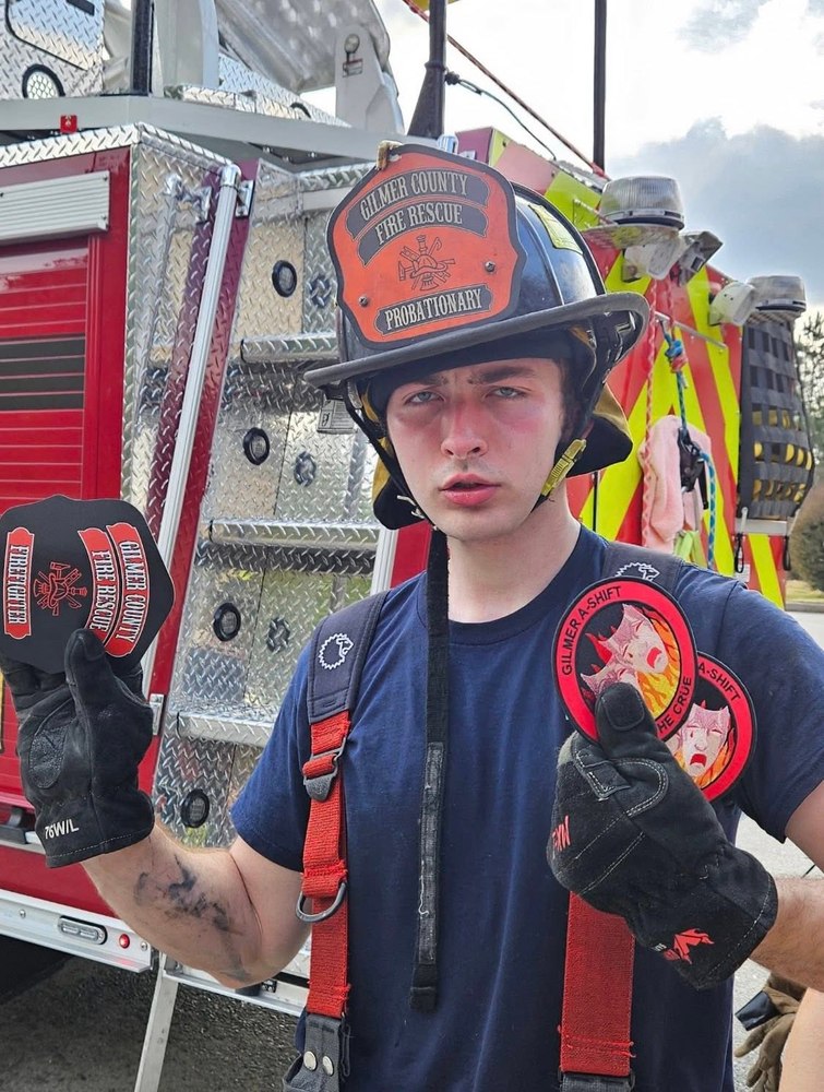 Probationary Gilmer County Fire/Rescue firefighter holding department patches