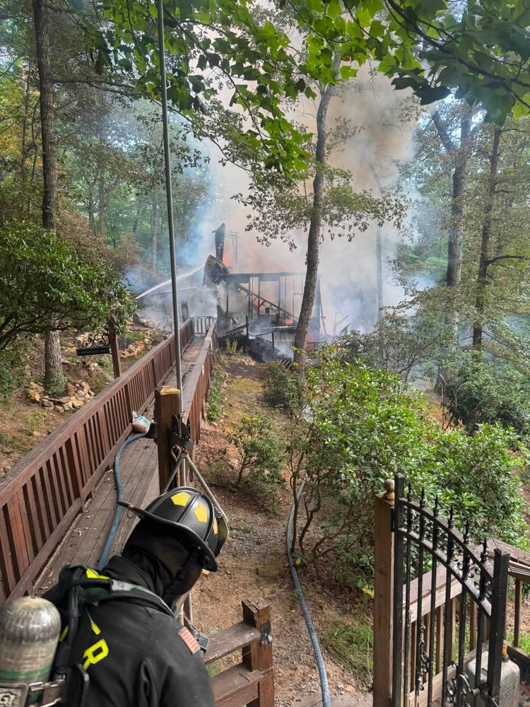 Gilmer County Fire/Rescue firefighter watching crews work a structure fire