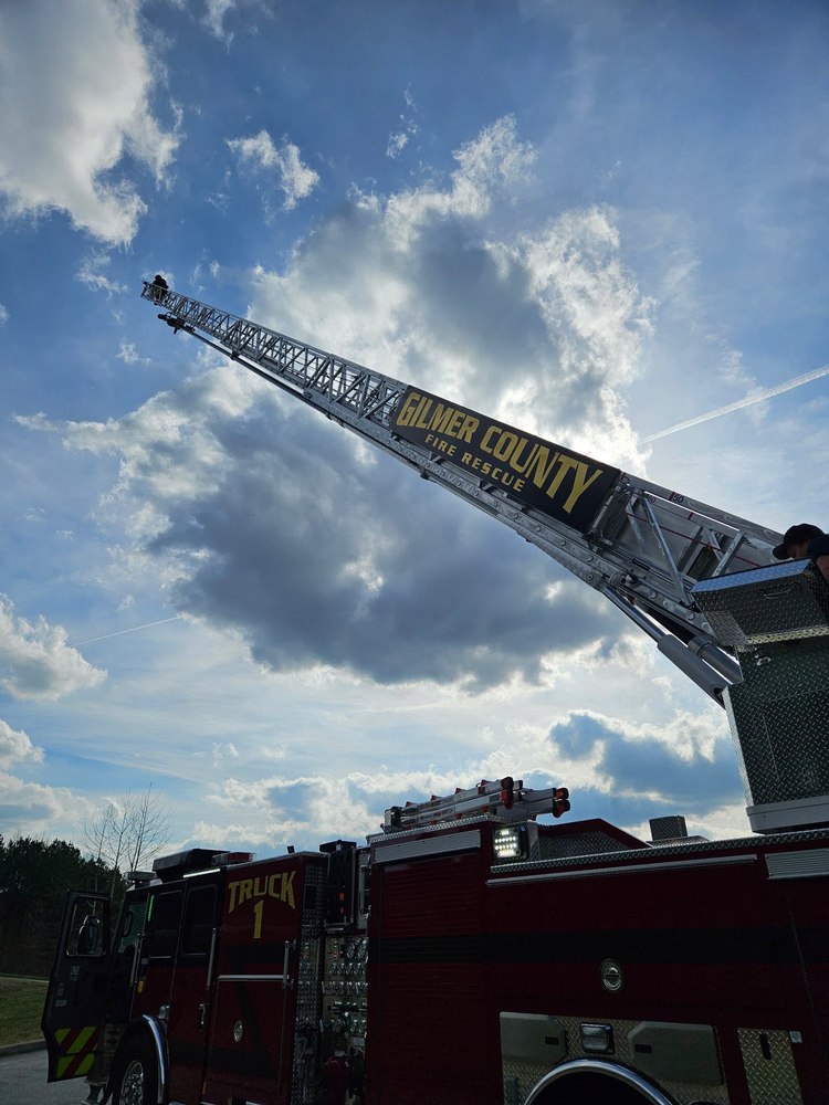 Gilmer County Fire/Rescue Truck 1 aerial ladder extended against the sky
