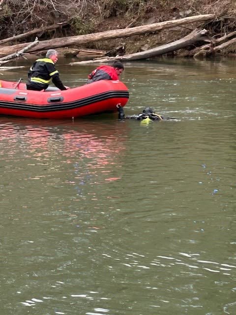 Gilmer County Fire/Rescue diver in the water during rescue training, supported from an inflatable boat