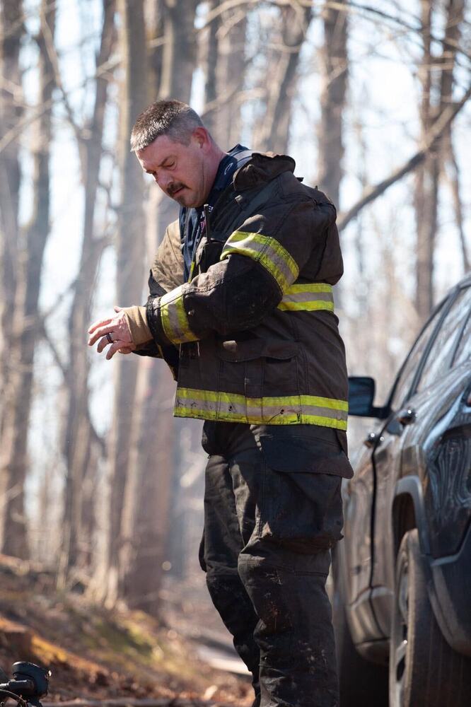 Eric Maddox on scene in turnout gear, checking his radio