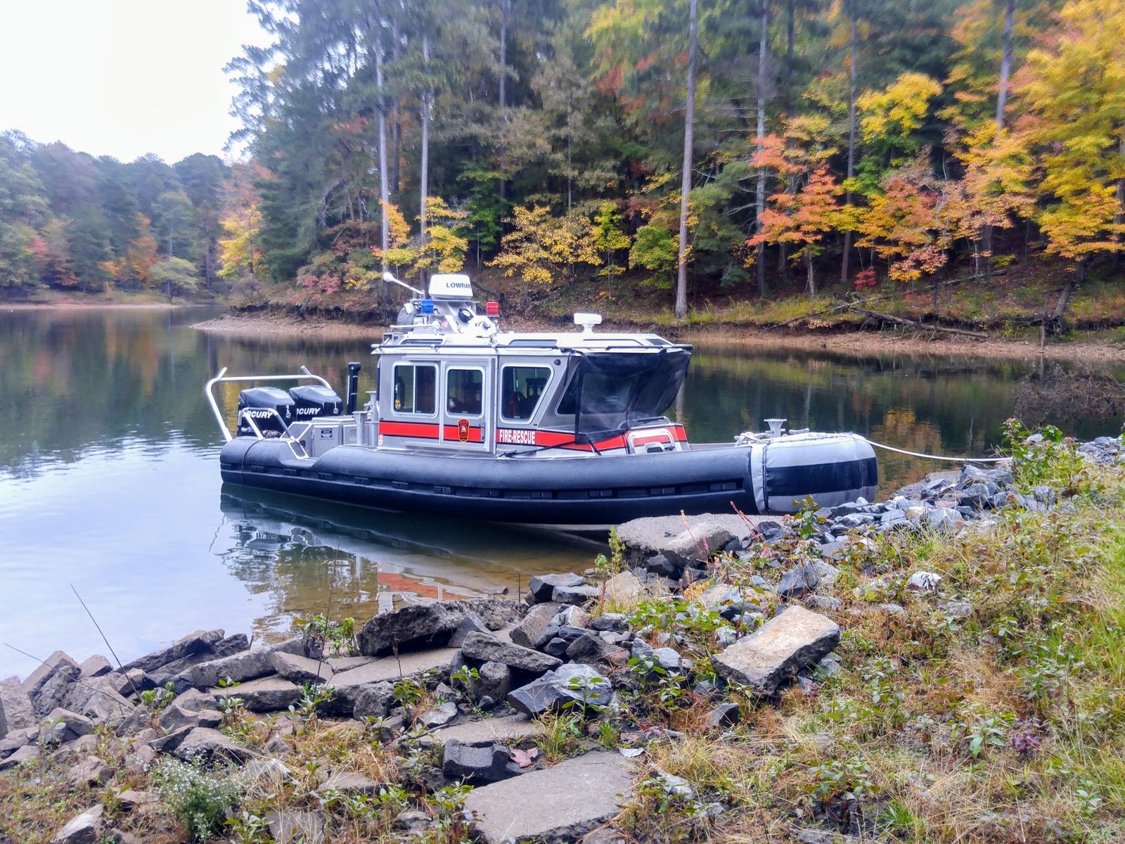 Gilmer County Fire/Rescue boat on a rocky shoreline in fall