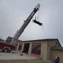 Gilmer County Fire/Rescue aerial ladder lifting a boat at the station