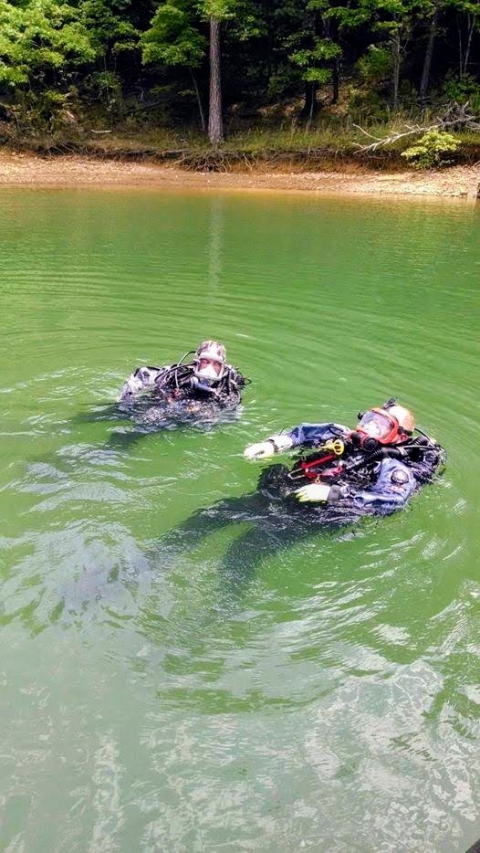 Gilmer County Fire/Rescue dive team members surfacing in green water