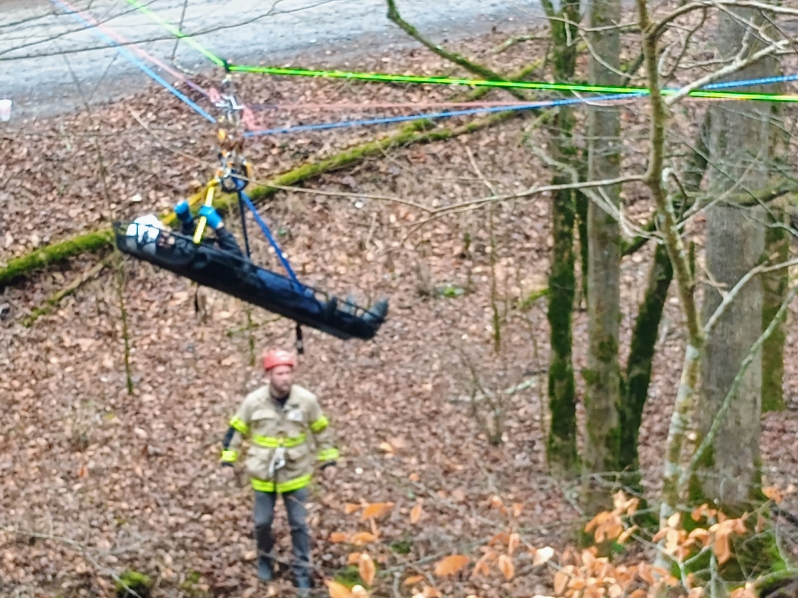 Gilmer County Fire/Rescue high-angle rescue litter lowered by rope through the woods